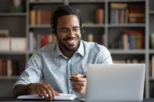 smiling contact center agent wearing headphones