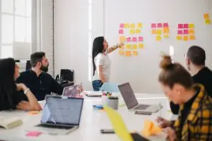 woman in a business meeting talking about the 4 types of communication styles in the workplace